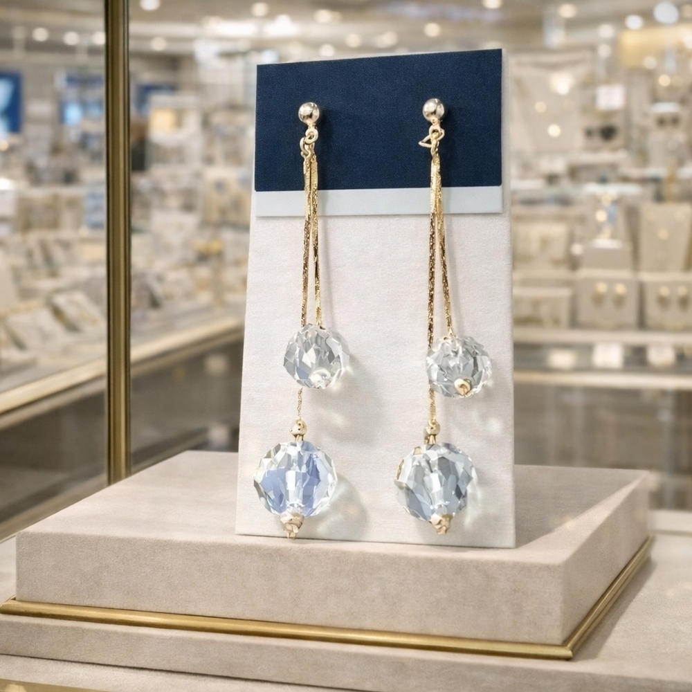 Gold dangling earrings with clear bead decor